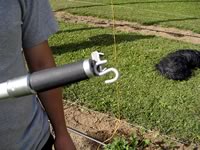 The S-hook in place with its bottom in the ring magnet and held upright by the bar magnet beside it